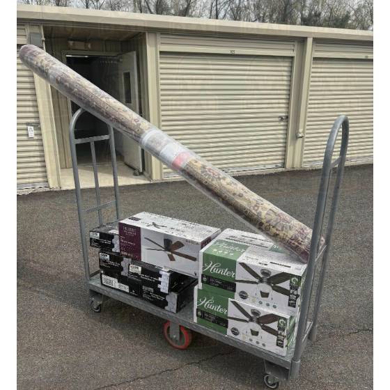 Home Depot flat cart loaded with a rolled Marash Red 8 by 10 rug, three boxed ceiling fans, and stacked tile boxes.