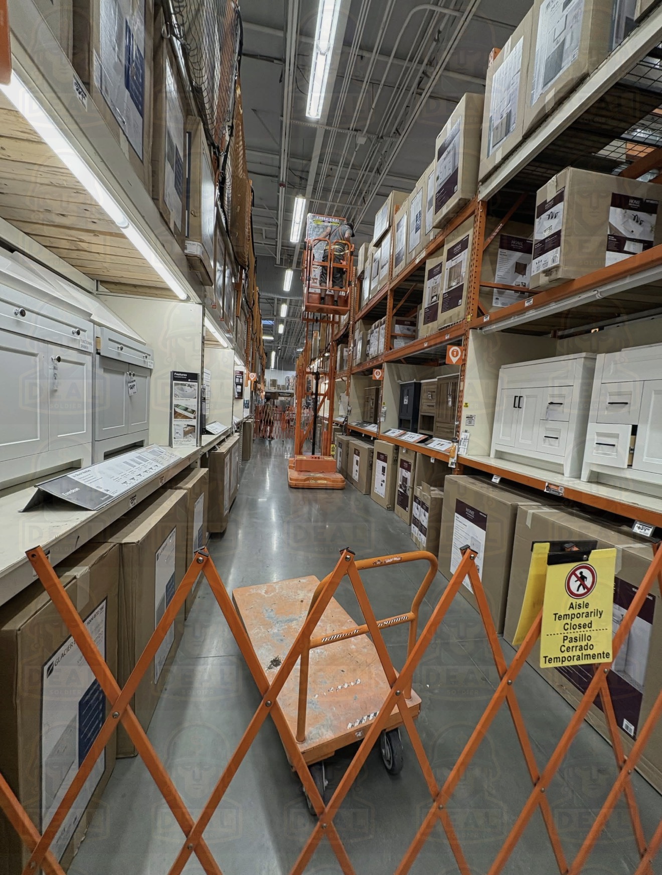 Home Depot vanity aisle interior shot showing rows of boxed vanity cabinets stacked on shelves with an aisle temporarily closed barrier in the foreground.