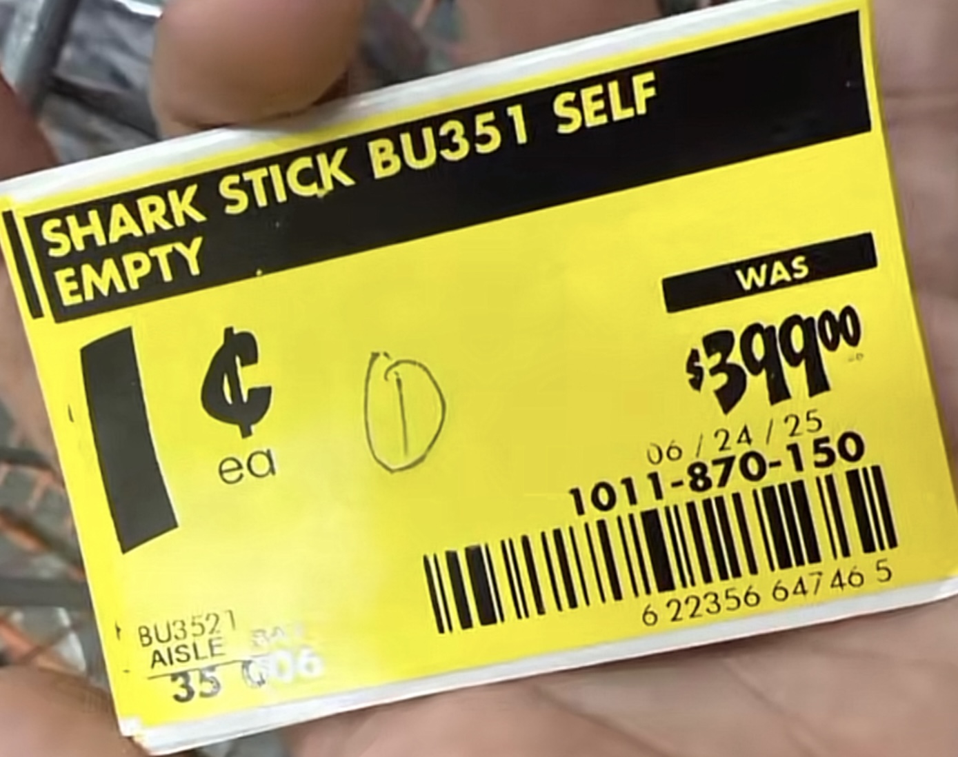 Real in-store Home Depot yellow clearance price tag for a Shark Stick BU351 self-empty vacuum. The tag shows the original price WAS $399.00 with the new price as a single ¢ symbol per each, confirming the vacuum rings up at one cent at the Home Depot register. Aisle BU3521, barcode 1011-870-150, dated 06/24/25.