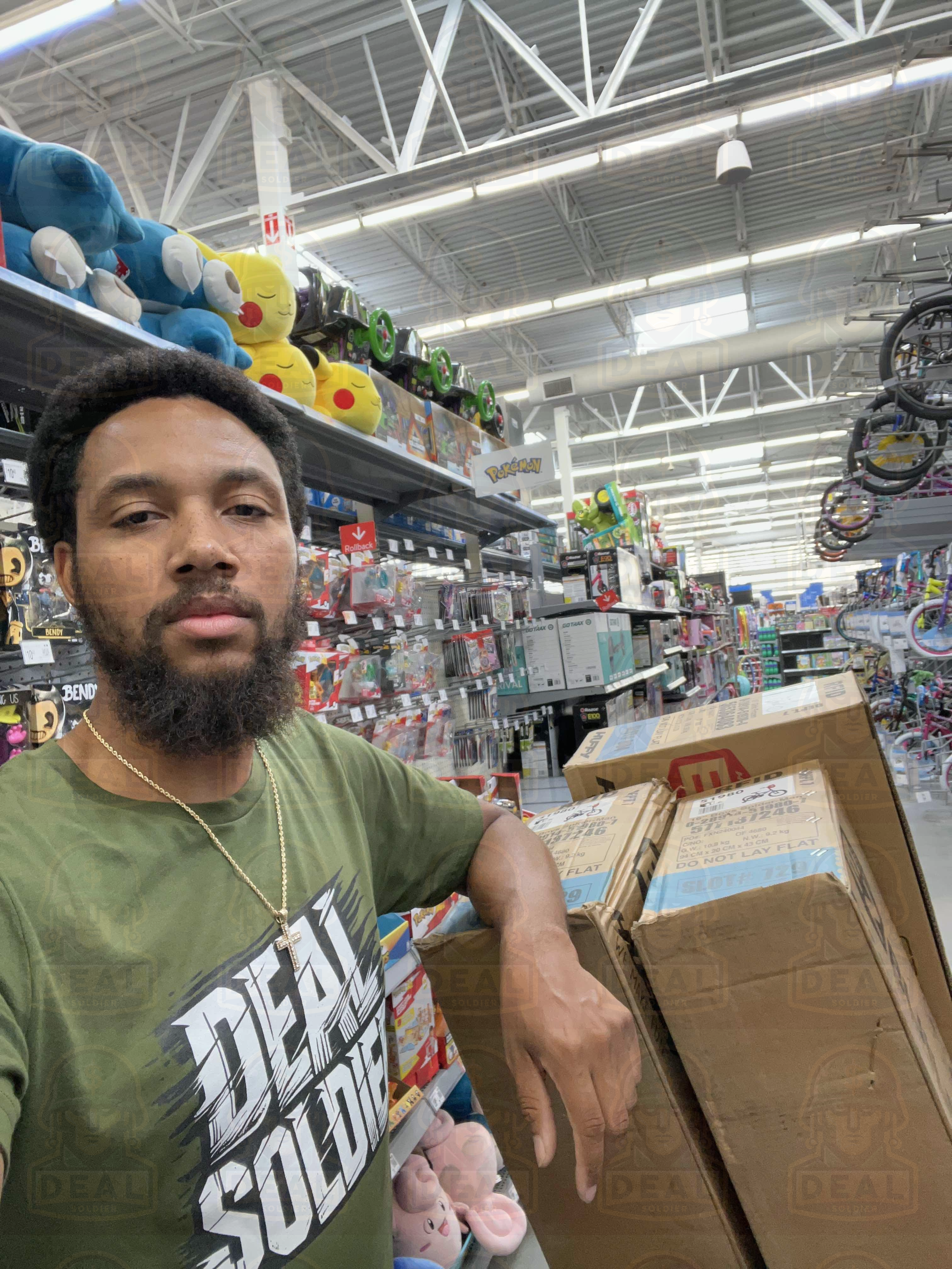 Deal Soldier member in Walmart toy aisle wearing a Deal Soldier shirt.