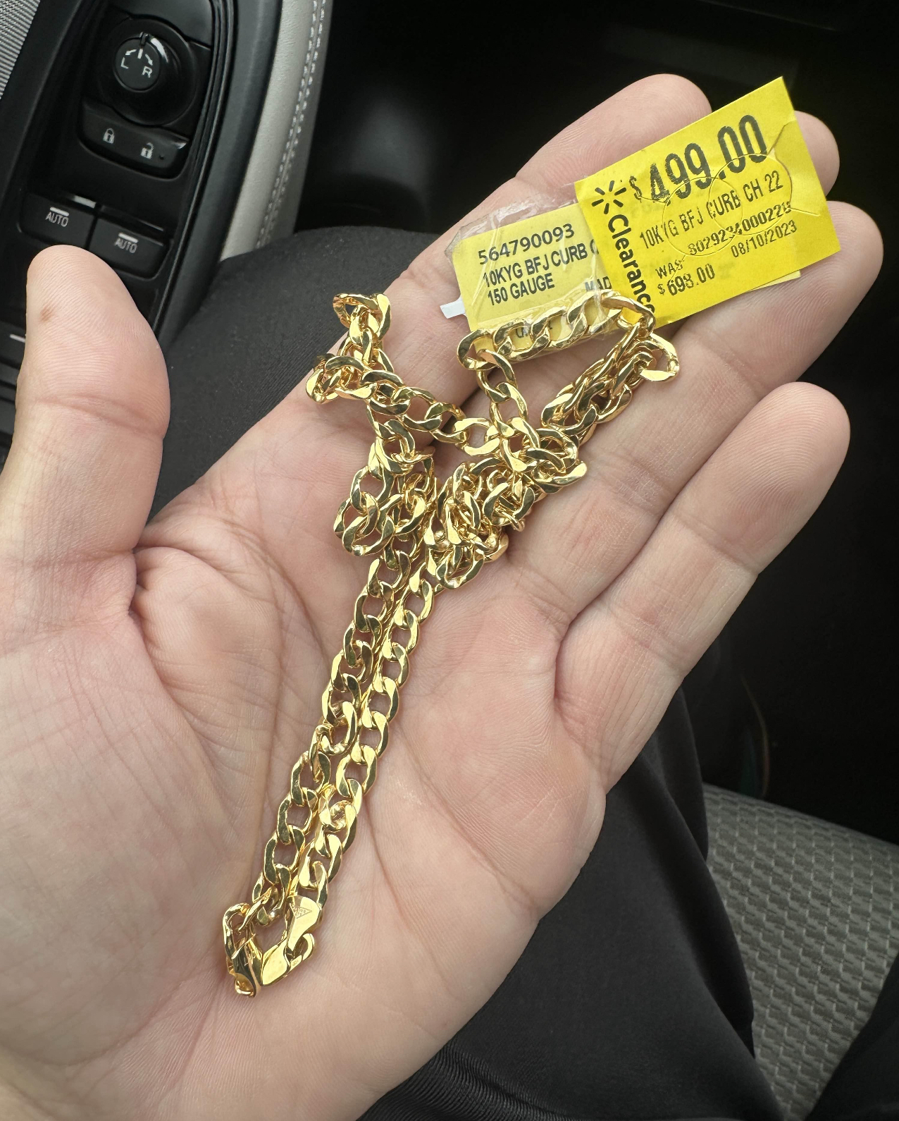 10K gold curb chain with a yellow Walmart clearance sticker showing $499 marked down from $699.