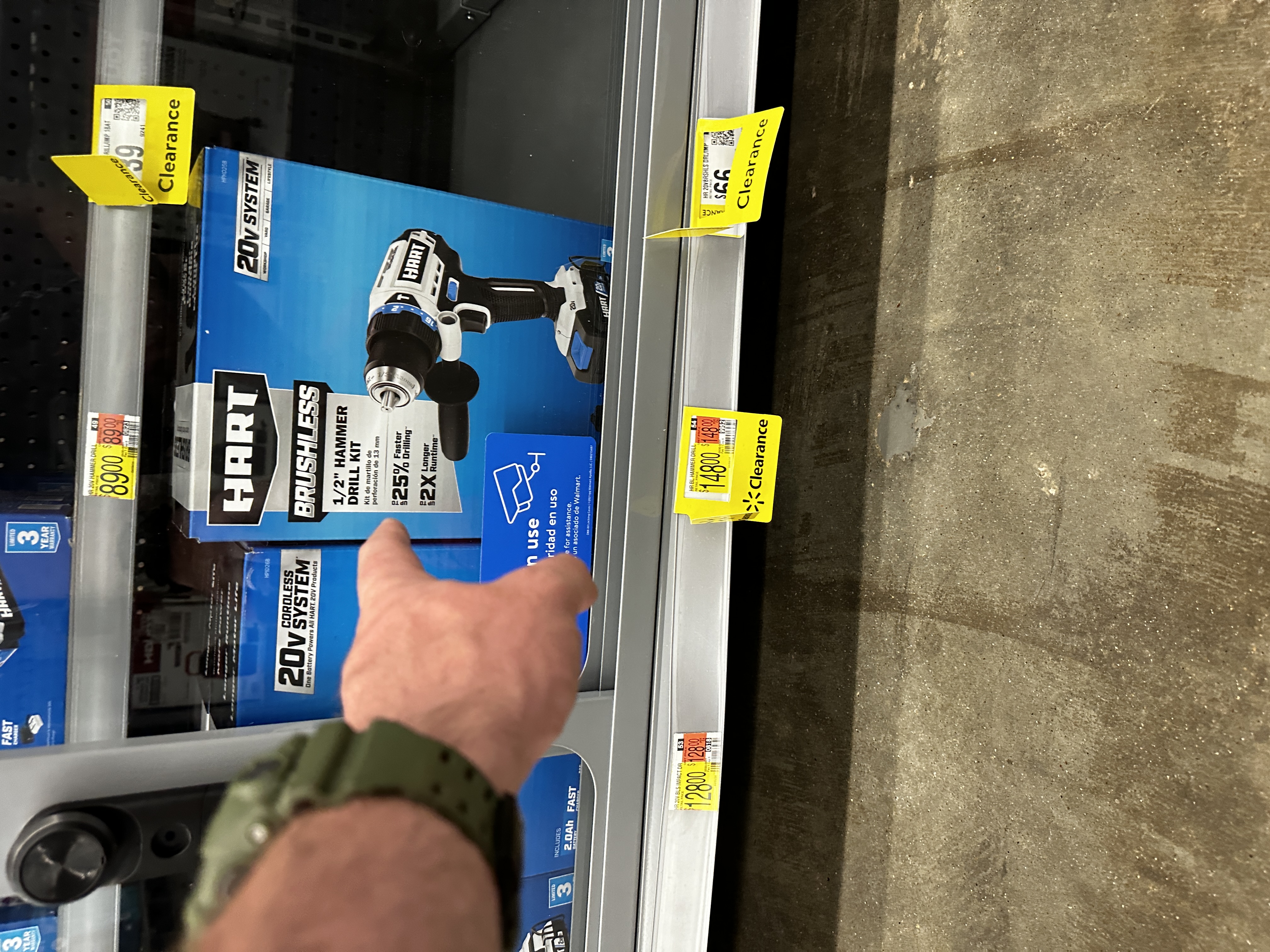 Walmart shelf with multiple yellow clearance tags on Hart drill kits.