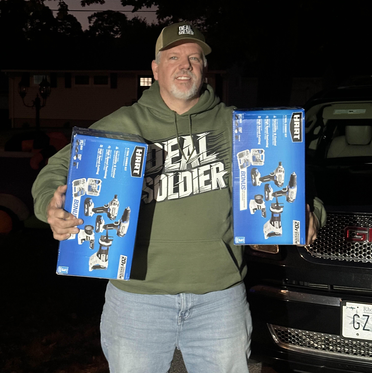 Deal Soldier member holding two Hart 20V cordless tool combo kits found on Walmart clearance.